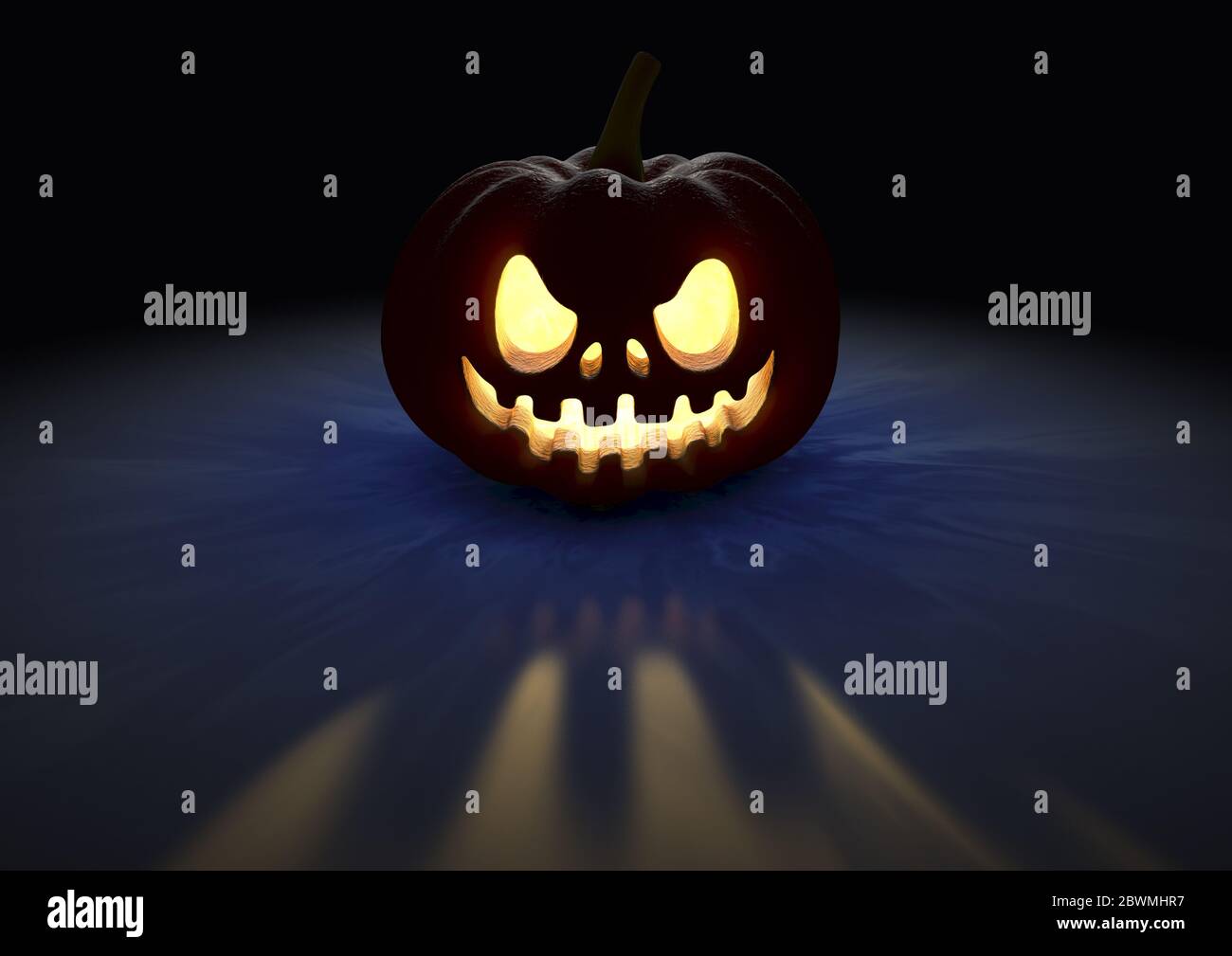 An illuminated halloween jack o lantern on an isolated dark background ...