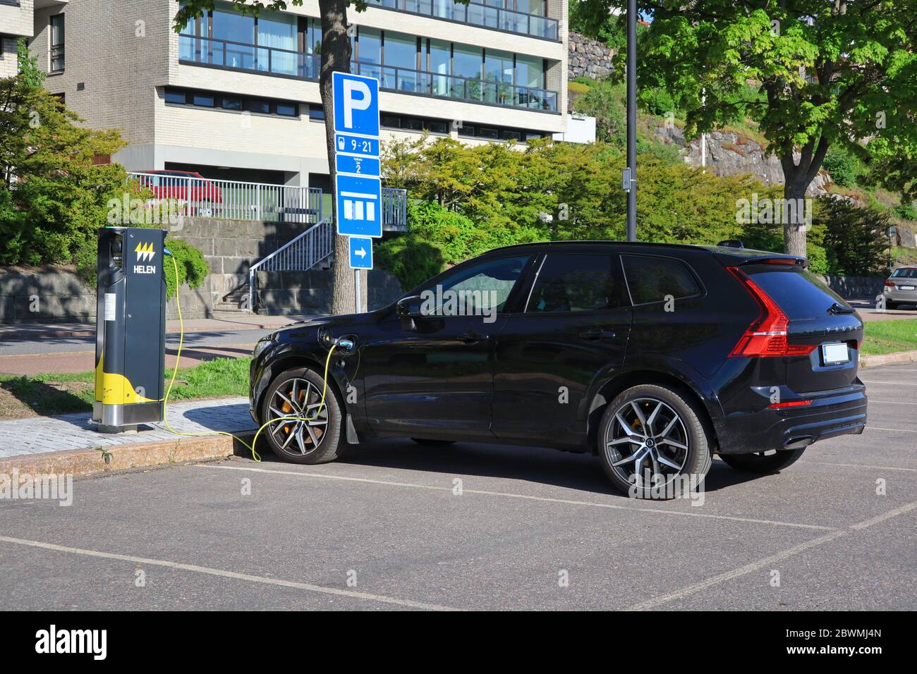 New Volvo XC Plug-in hybrid electric SUV charging battery, rear view, plugged in Helen Charging Point. Helsinki, Finland. June 2, 2020. Stock Photo