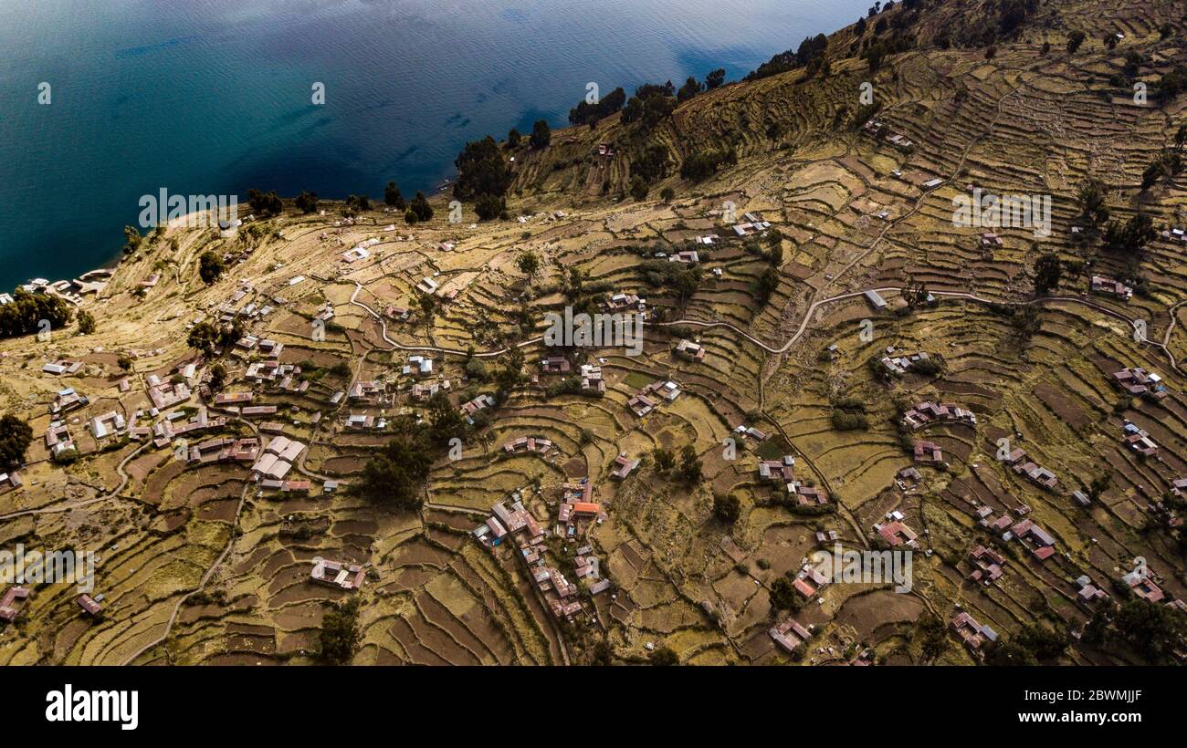 Aerial view on terraced slopes of Taquile island on Titicaca Lake with other islands in the background. World's highest navigable lake view. Stock Photo