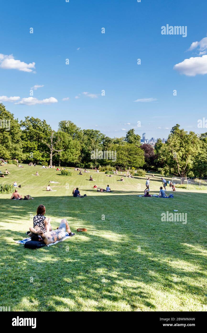 People sunbathing in Waterlow Park during the coronavirus pandemic lockdown, not all observing social and physical distancing advice, North London, UK Stock Photo