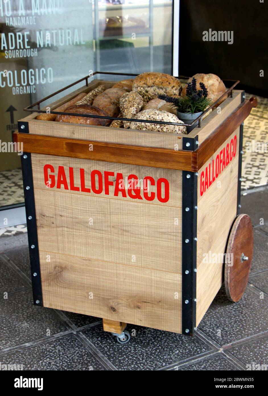 Wooden trolley displaying various bread outside a bakery early morning Valdenoja Santander Spain Stock Photo