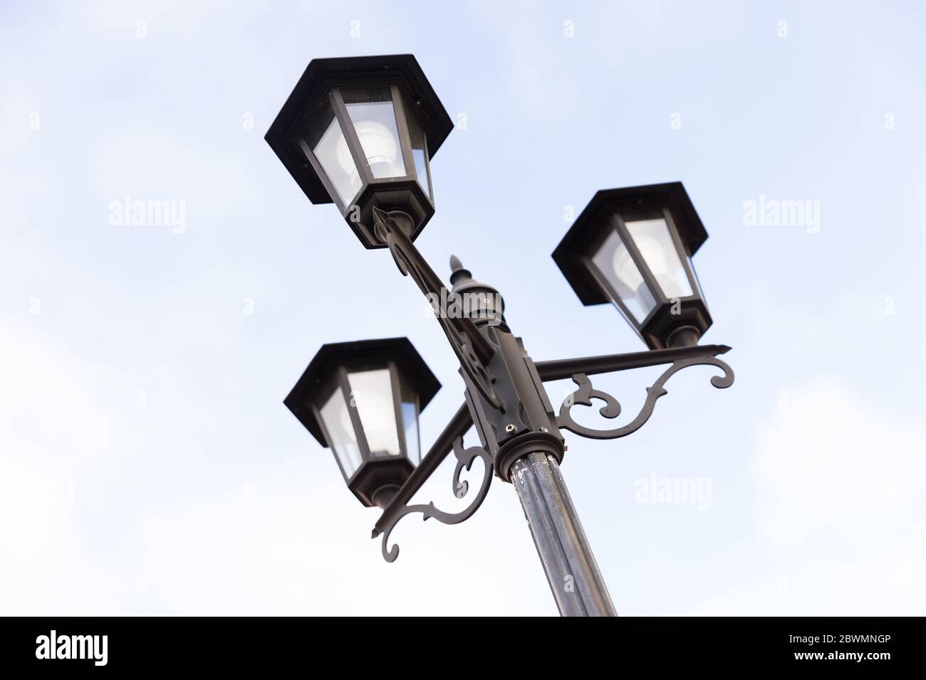 Classic triple streetlight with glass lamps Stock Photo Alamy