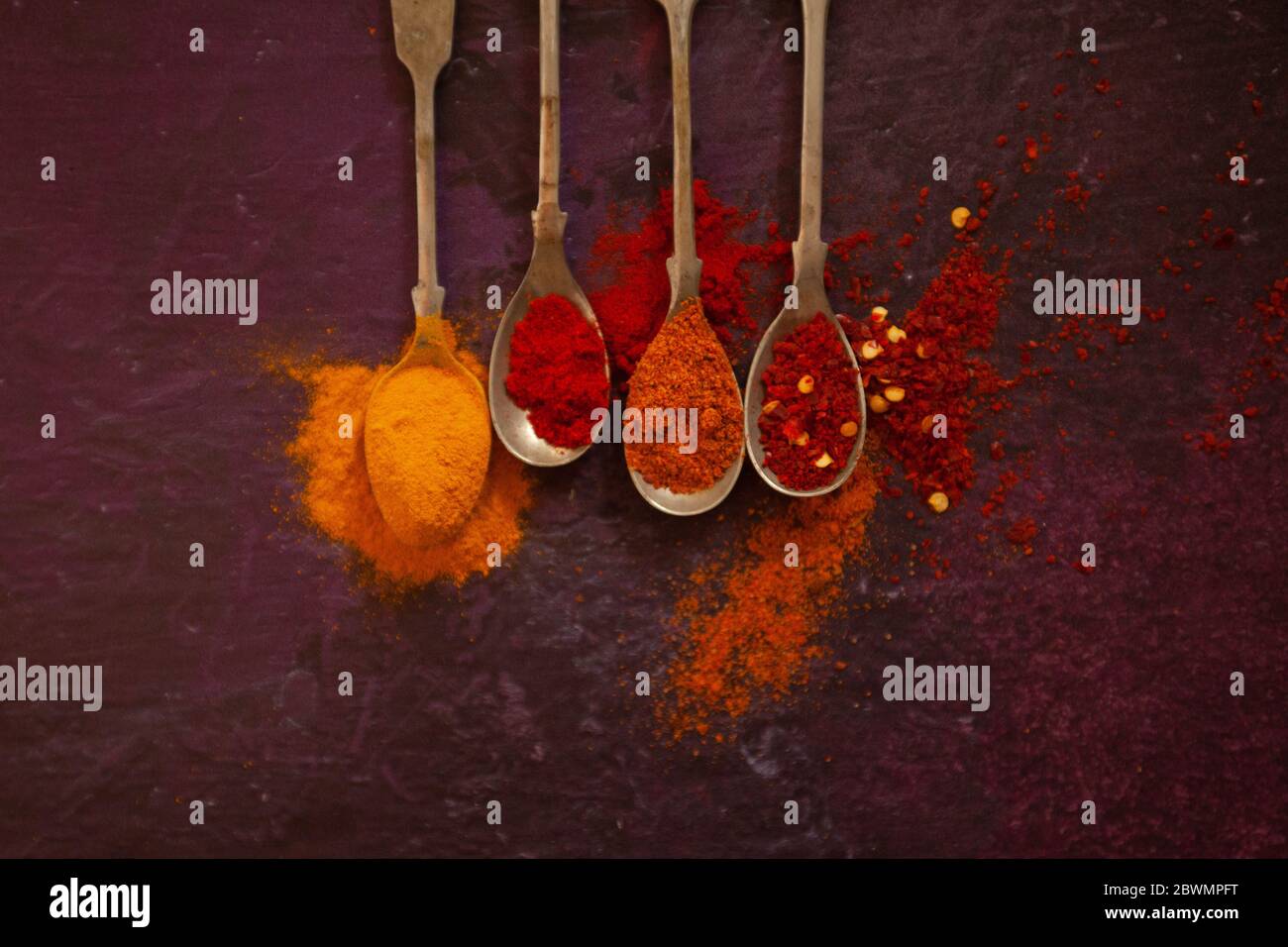 Spices on silver spoons Stock Photo