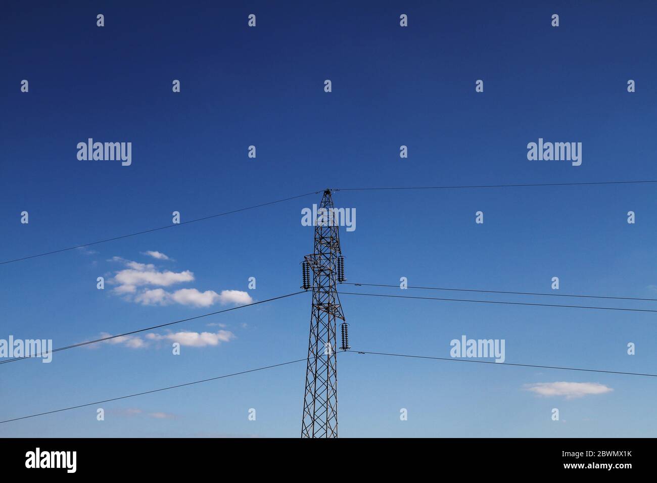 high voltage power line blue sky with clouds Stock Photo - Alamy