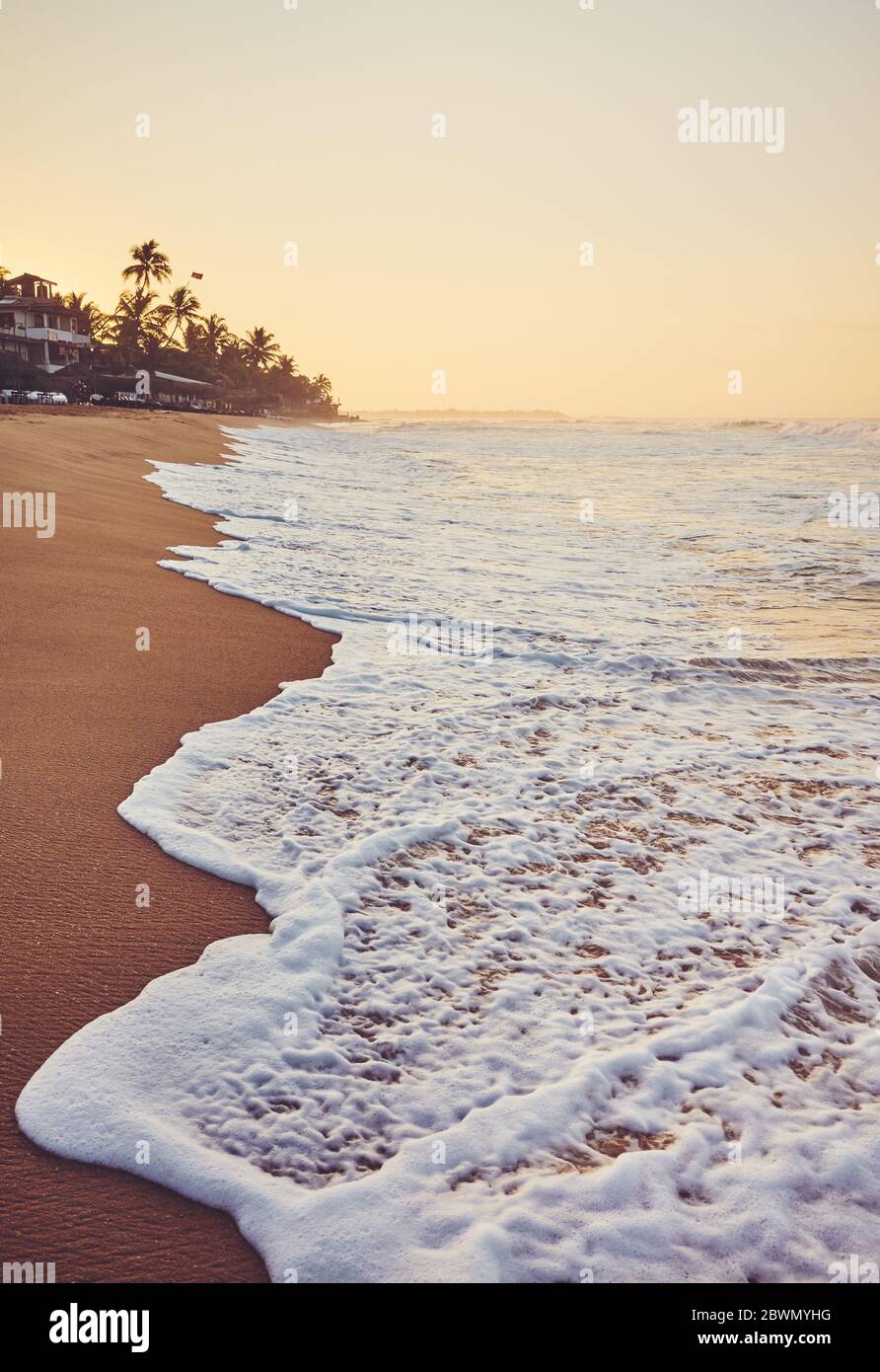 Tropical beach at sunrise, color toning applied, Sri Lanka. Stock Photo