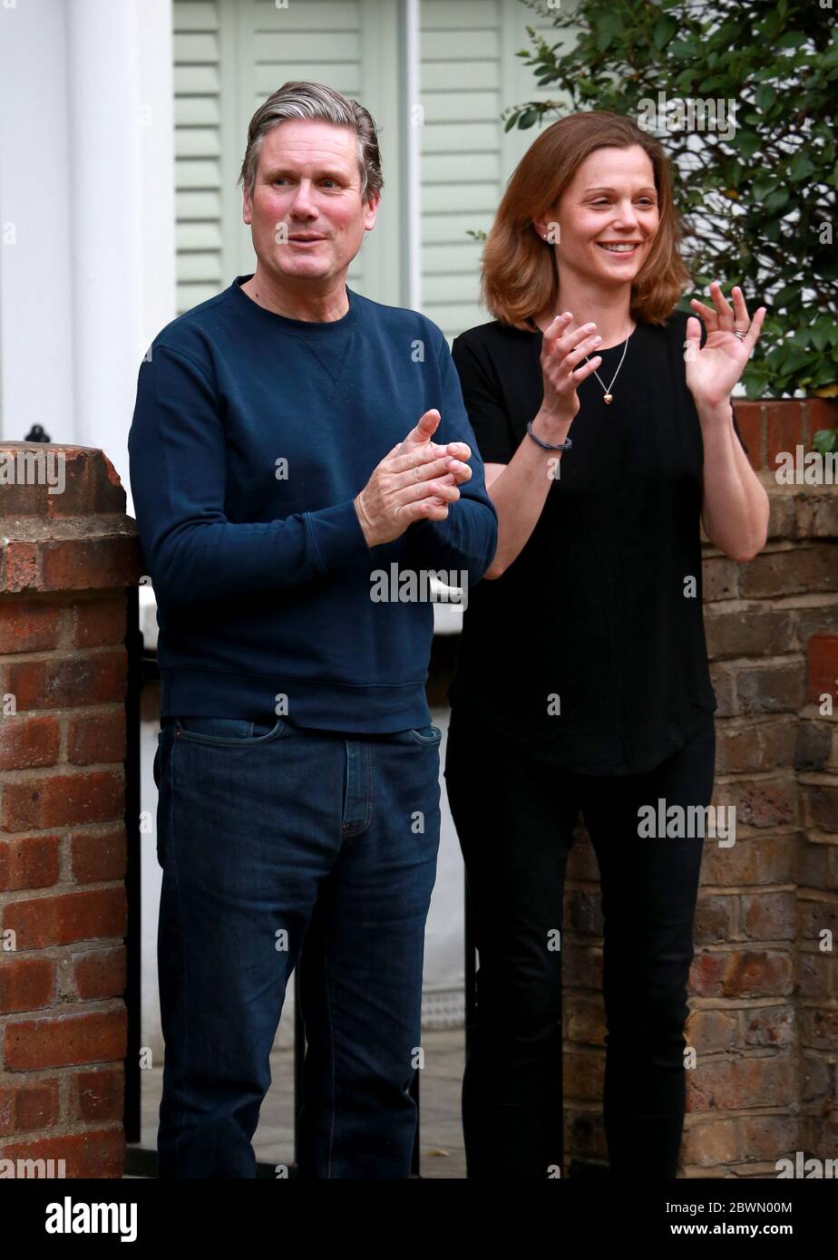 May 21, 2020: Sir Keir Starmer and Victoria Starmer applaud for key workers outside their home in north London, UK. Stock Photo