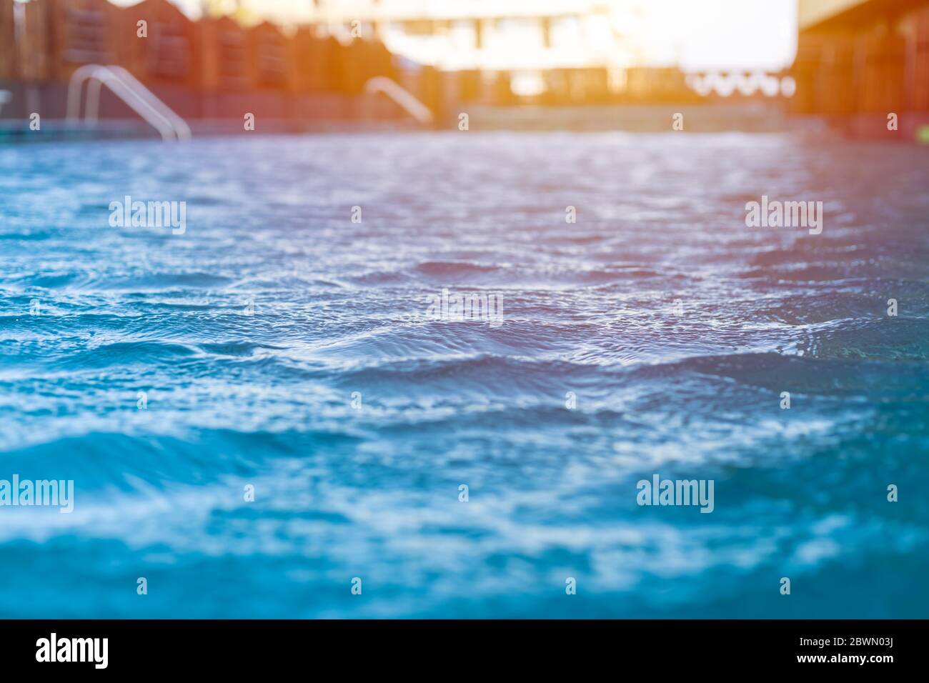 Blue lagoon cool water swimming pool wave ripple closeup with sunny light cooling feel in summer day. Stock Photo