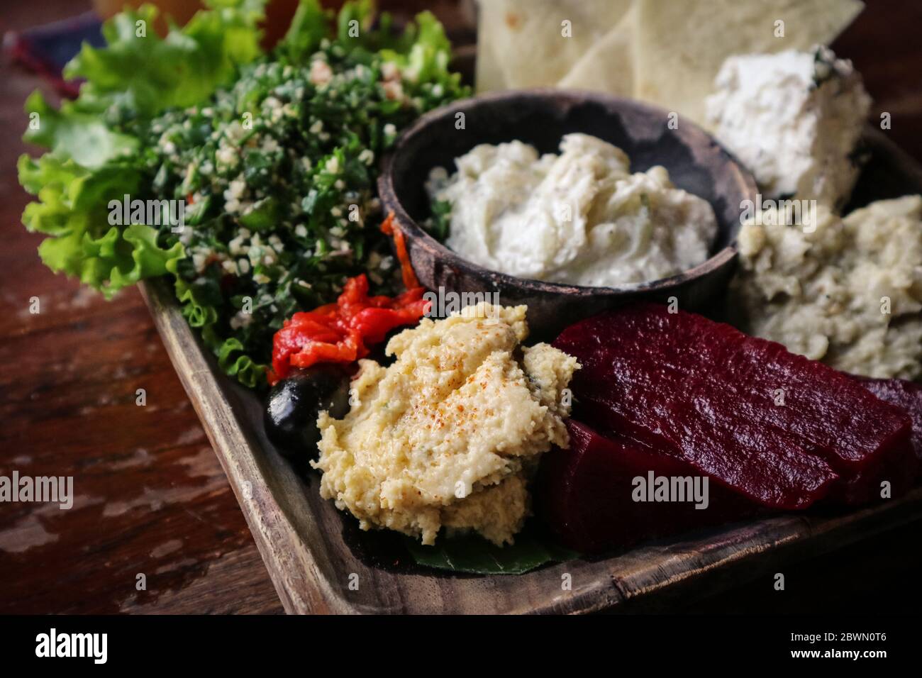 Mezze Platter with hummus, babaganoush, tabouli, roasted peppers, beet, feta cheese and kalamata olives served with pita bread Stock Photo