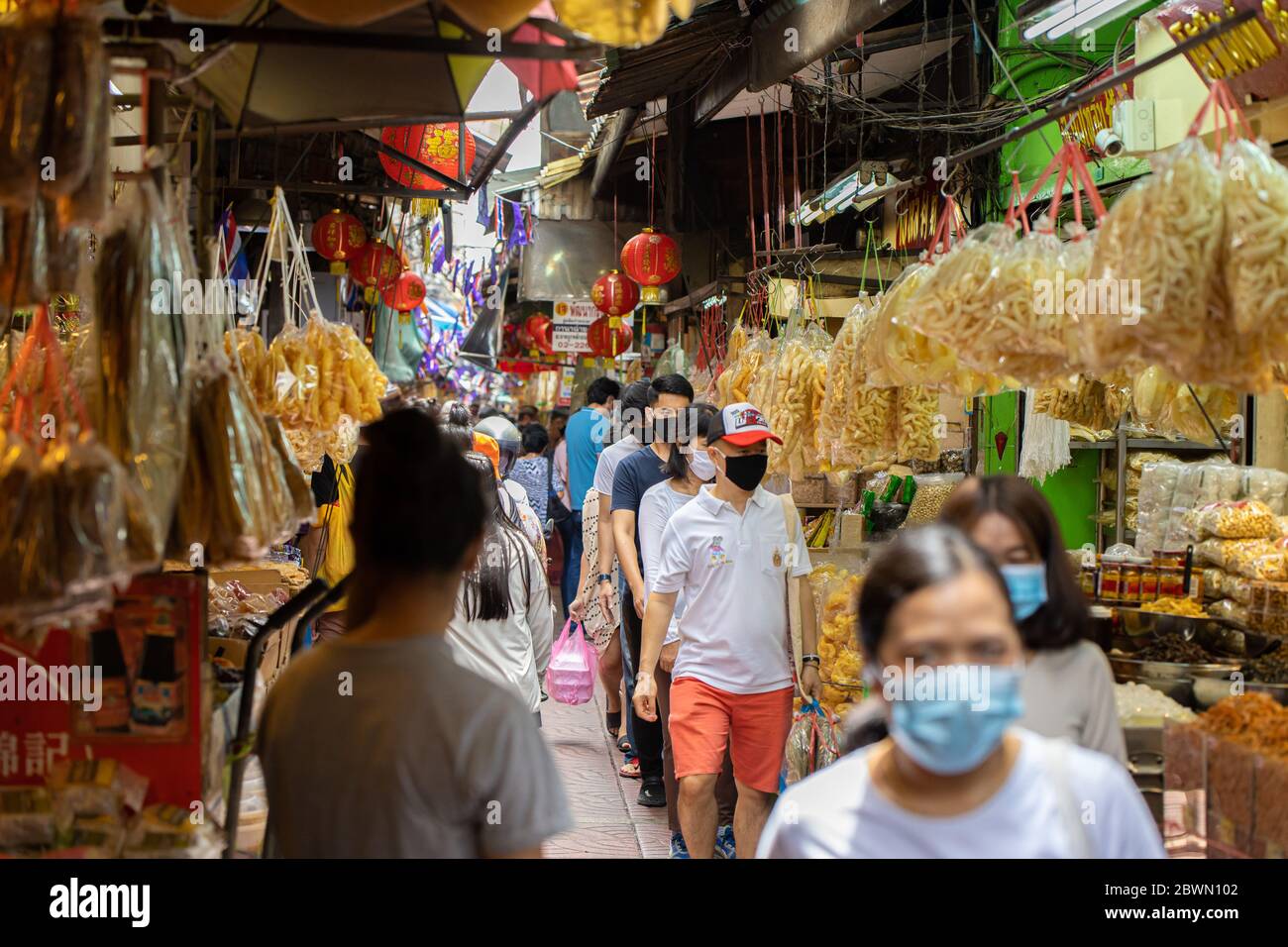 Crowd of people walking shopping for Chinese food resource in Chinatown Yaowarach market and waring face mask for protect Coronavirus(Covid-19). 30 Ma Stock Photo