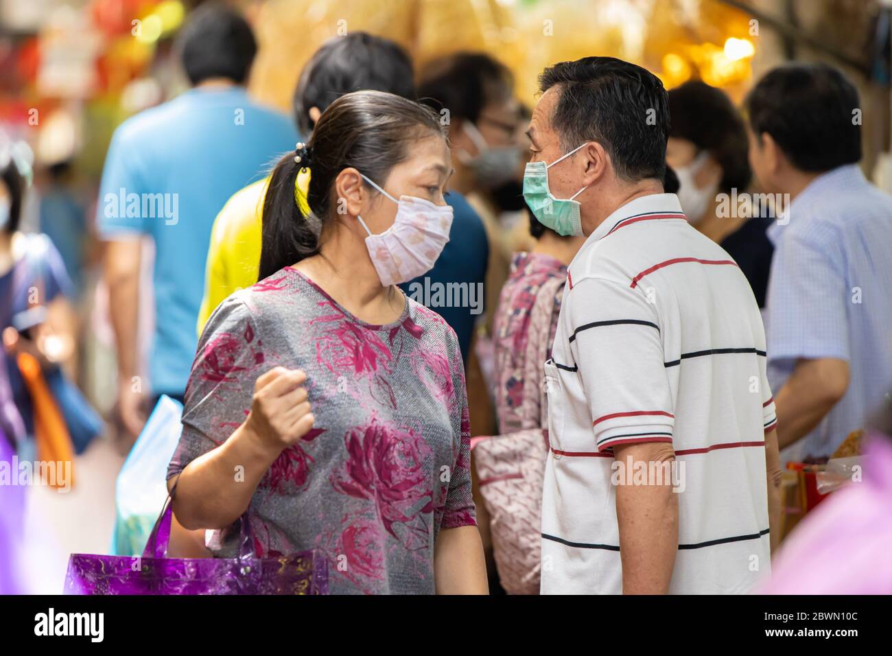 People walking shopping for Chinese food resource in Chinatown Yaowarach market and waring face mask for protect Coronavirus(Covid-19). 30 May 2020, B Stock Photo