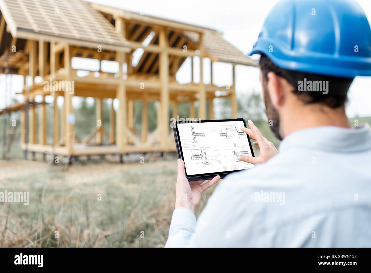 Architect or builder using digital touchpad on the construction site outdoors. Close-up on screen with copy space Stock Photo
