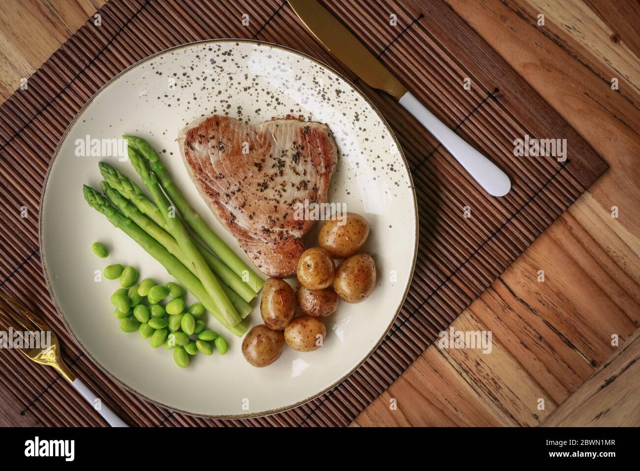 Grilled tuna steak served with asparagus, roasted baby potatoes