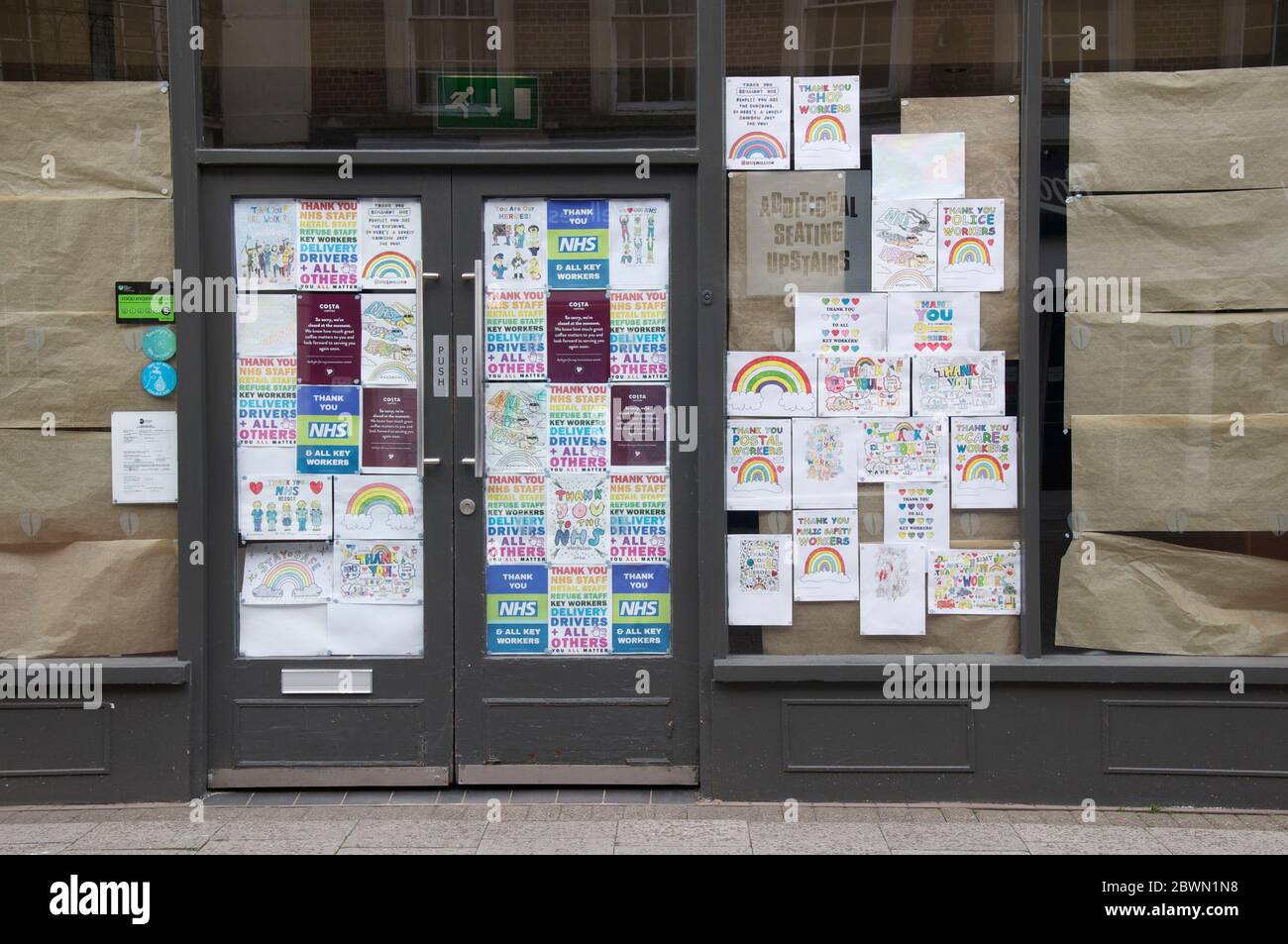 Window of a shut down Costa Coffee adorned with messages and drawings in praise of NHS and essential workers during the Covid 19 pandemic. England. UK. Stock Photo