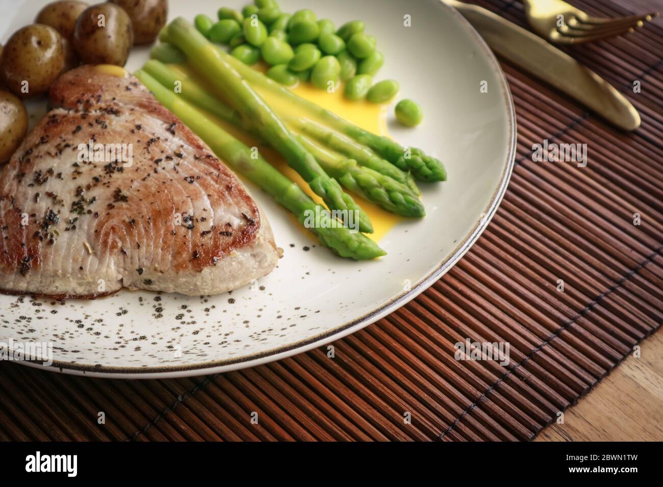 Grilled tuna steak served with asparagus, roasted baby potatoes