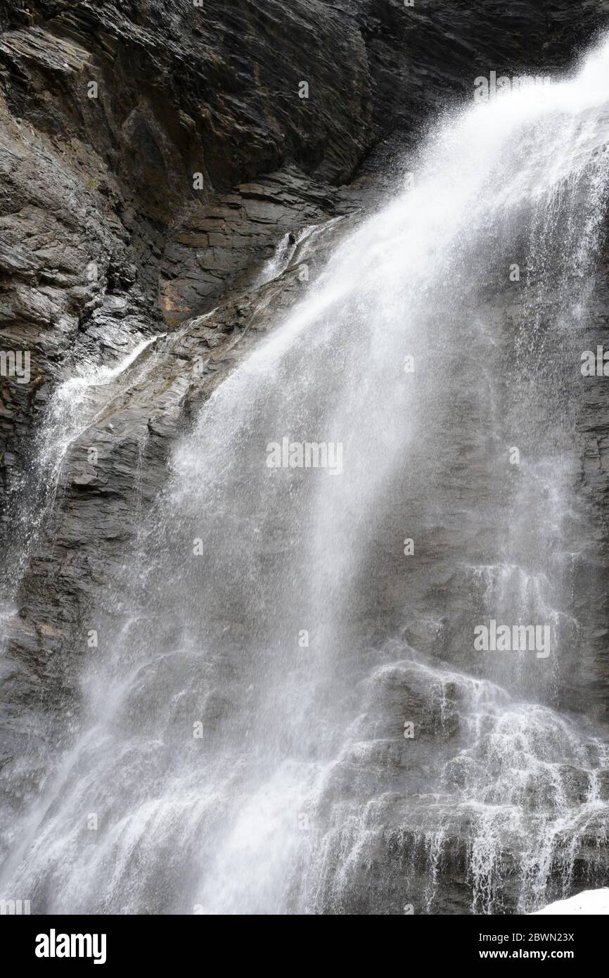 Beautiful waterfall falling hard on black rocks. Stock Photo