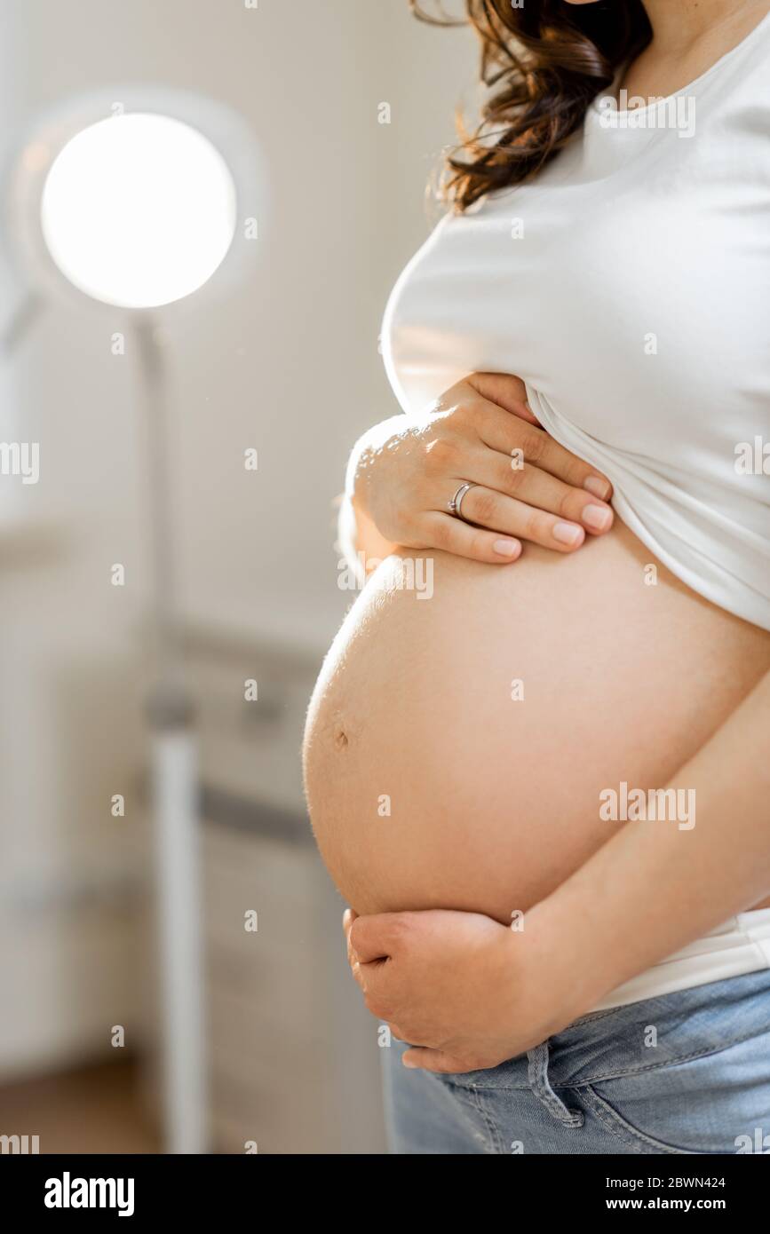 Close-up of a pregnant woman&apos;s belly in a gynecological office Stock P...