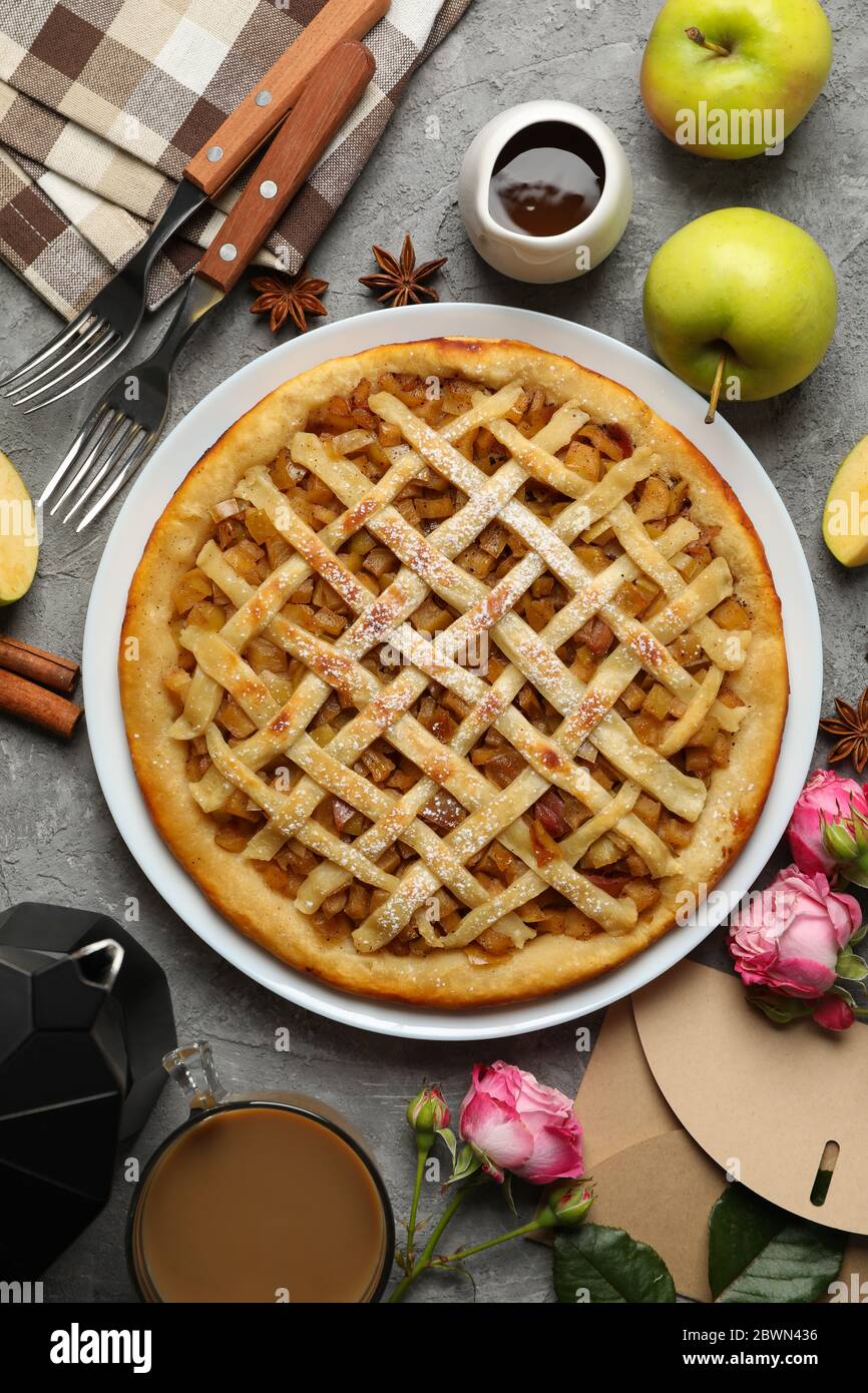 Composition with apple pie and ingredients on gray background, top view Stock Photo