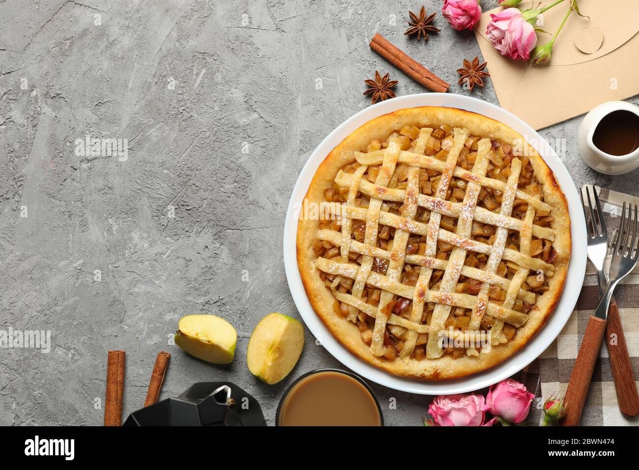Composition with apple pie and ingredients on gray background, top view Stock Photo