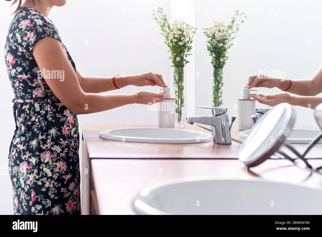 Woman washing her hands with soap at her bathroom Stock Photo - Alamy