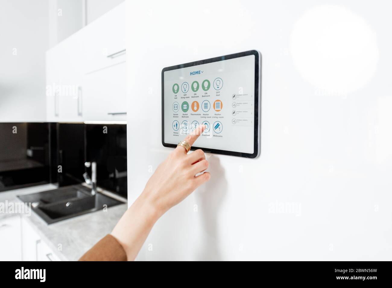 Controlling kitchen appliances with a digital tablet on the wall with  launched smart home application, close-up. Smart home concept Stock Photo -  Alamy