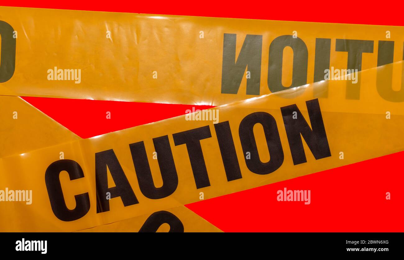 Yellow caution tapes crossing. Isolated. Red background. Protection
