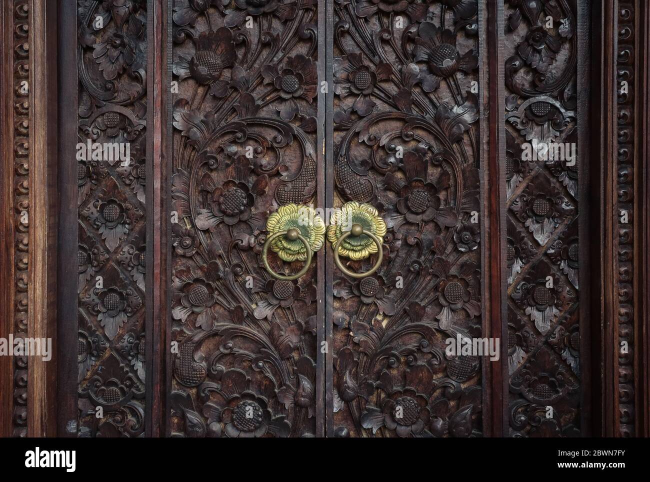Traditional balinese closed carved doors closeup Stock Photo