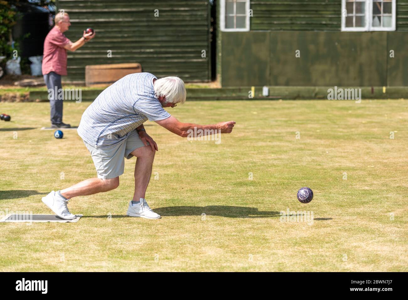 Willingham Cambridgeshire, UK. 2nd June, 2020. Members of the Willingham Bowls Club take part in a roll up on the local green as lockdown from the Covid 19 quarantine is lifted and rules allow the start of some outdoor sports. Competitive matches are still not allowed as lanes are left unoccupied to allow for social distancing. Credit: Julian Eales/Alamy Live News Stock Photo