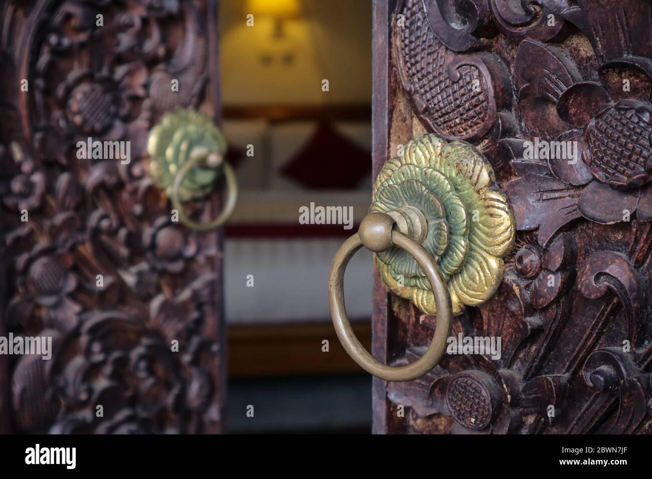 Traditional balinese opened carved doors closeup Stock Photo
