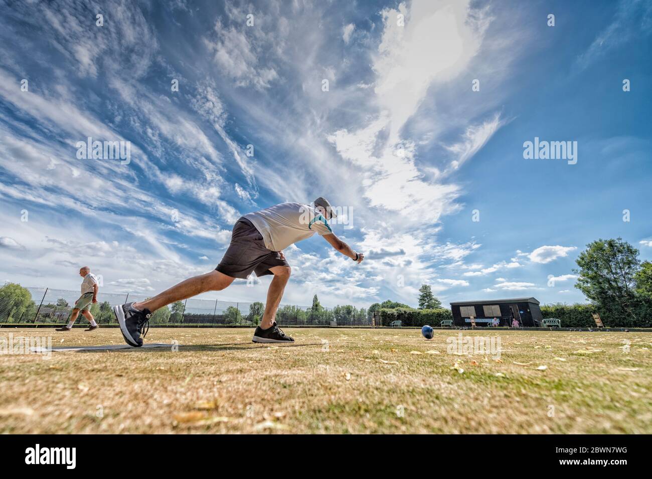 Willingham Cambridgeshire, UK. 2nd June, 2020. Members of the Willingham Bowls Club take part in a roll up on the local green as lockdown from the Covid 19 quarantine is lifted and rules allow the start of some outdoor sports. Competitive matches are still not allowed as lanes are left unoccupied to allow for social distancing. Credit: Julian Eales/Alamy Live News Stock Photo