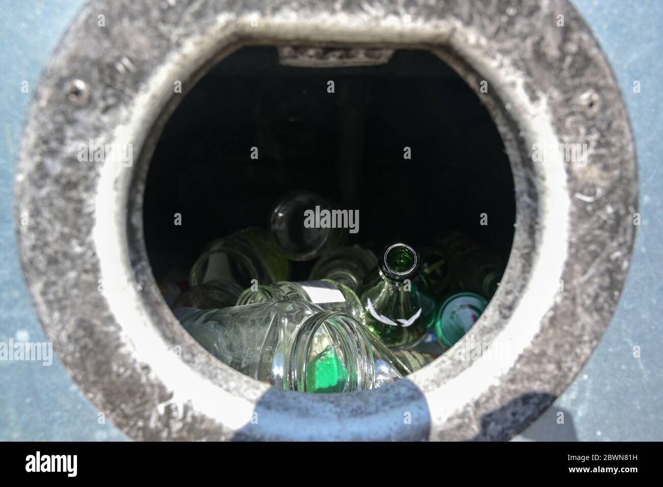 Insertion hole of a bottle container for collecting and recycling glass material, sustainable resource processing, copy space, selected focus, narrow Stock Photo