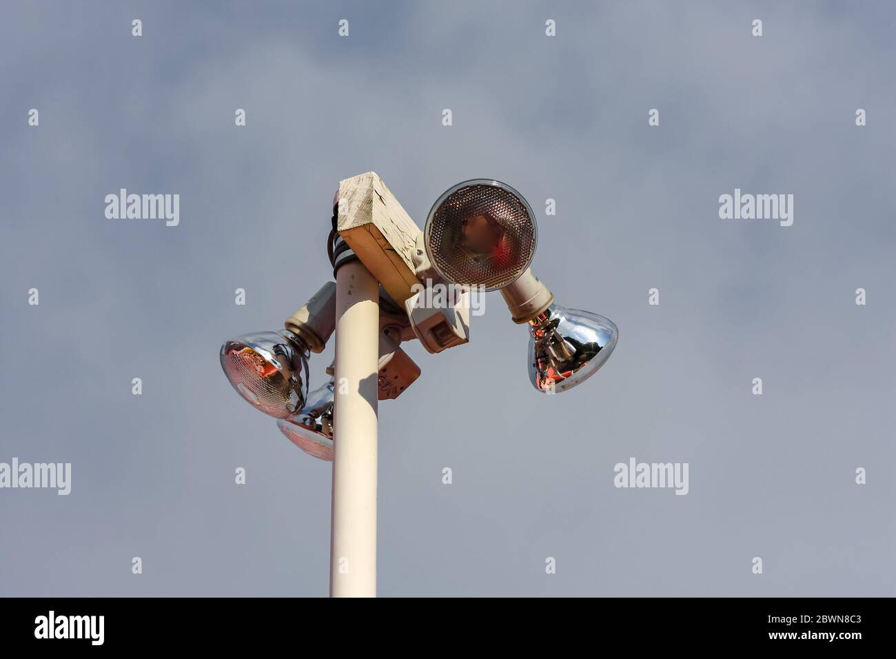 Outdoor security spotlights stand tall and are photographed from below