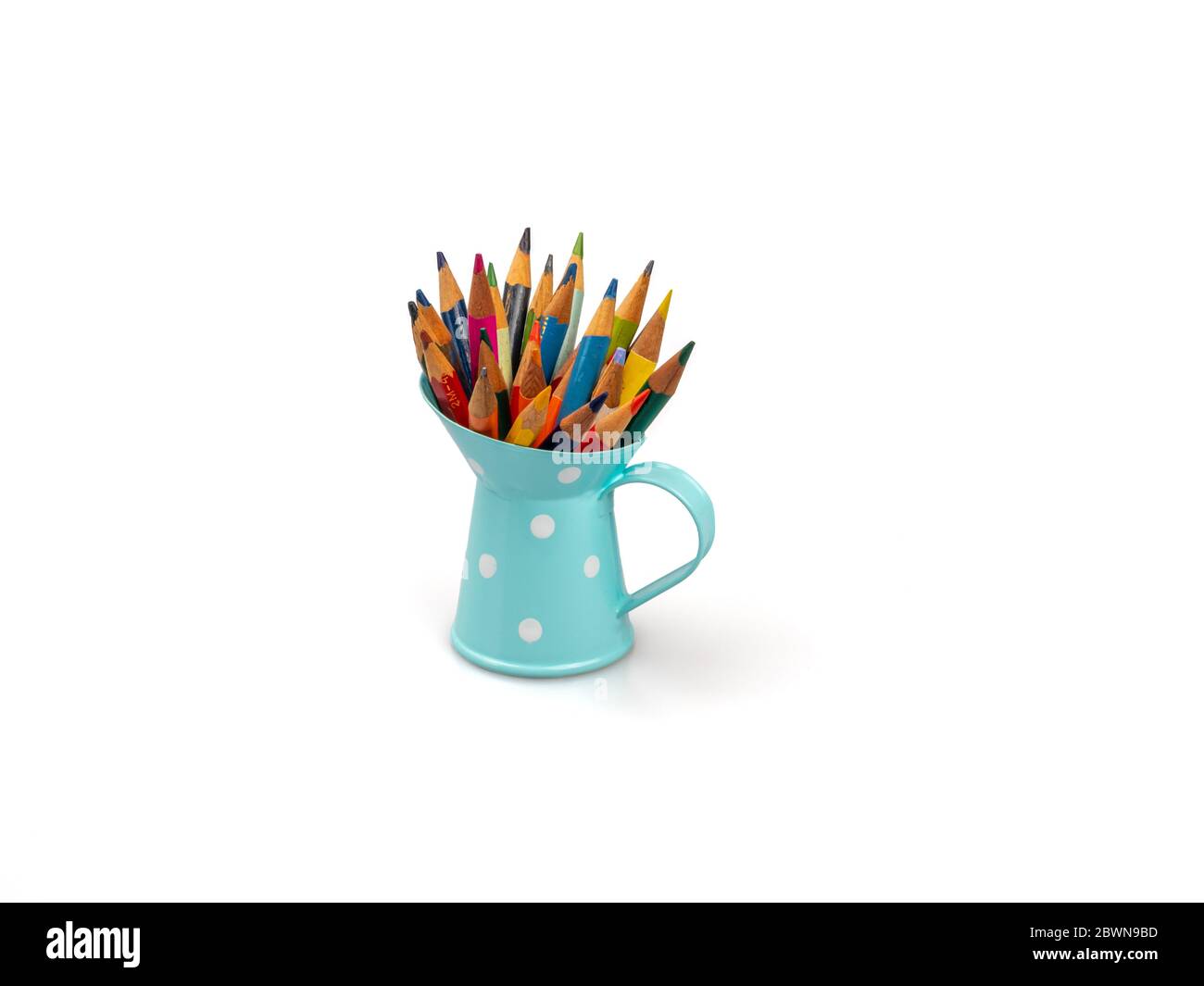 Colored pencils in a jar on a white background. Stock Photo
