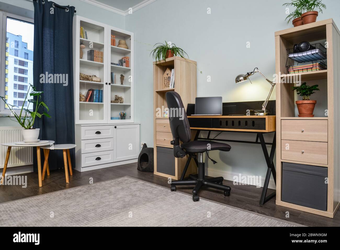 Light cozy teen room with white bookcases, working desk and laptop on ...