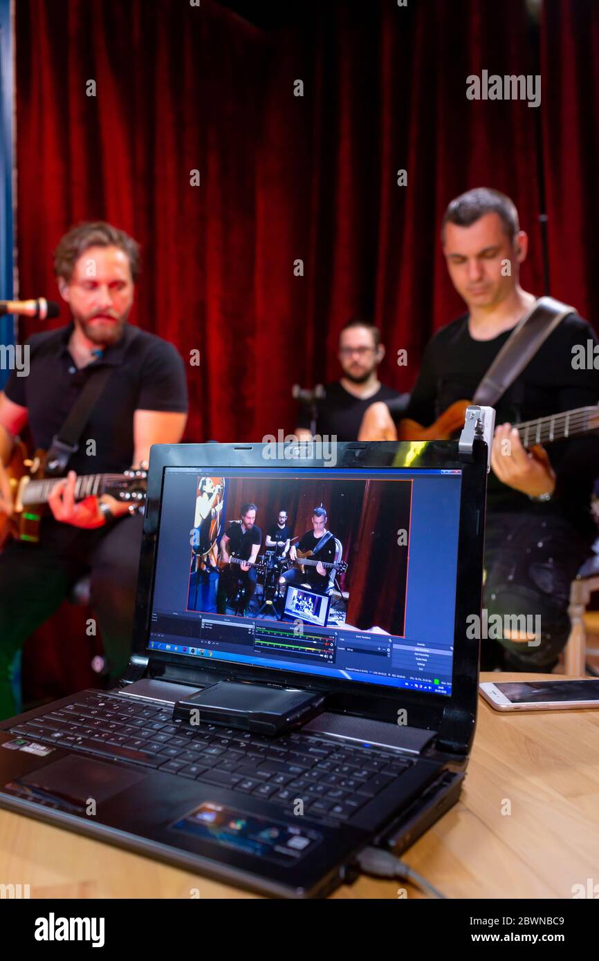 Bass Guitar player, Electric Guitar player and Drummer behind the drum