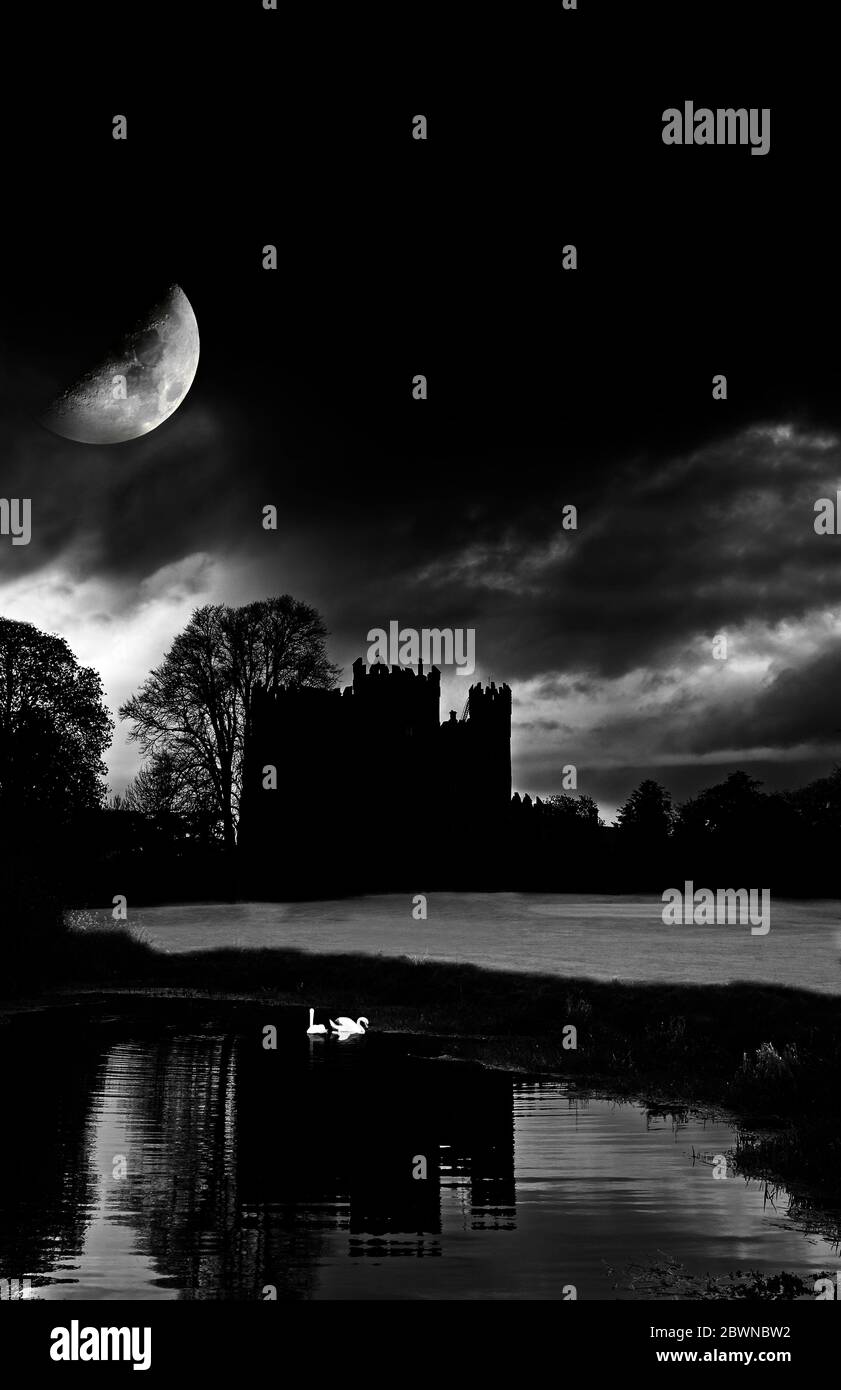 Moonrise over a haunted looking Kilkea Castle (now a luxury hotel) built in 1180 by Hugh de Lacey, Kilkea, County Kildare, Ireland Stock Photo