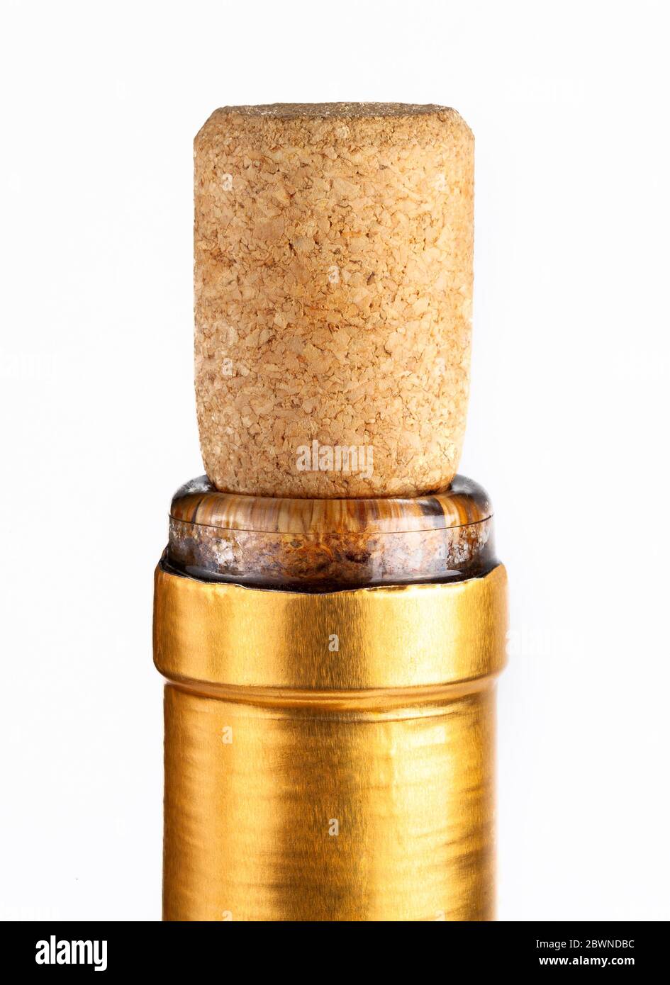 Gold premium wine bottle cork macro, closeup Cork sitting tight, closed golden bottle neck wrapping, side view, top part up close Stock Photo
