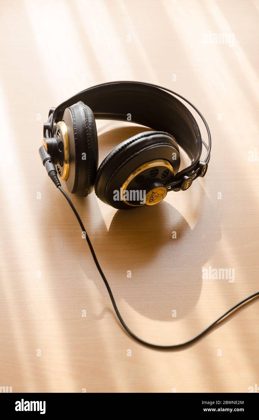 AKG k240 studio hi-fi headphones on wooden desk or table, backlit, natural  light, indoors, still life Stock Photo - Alamy