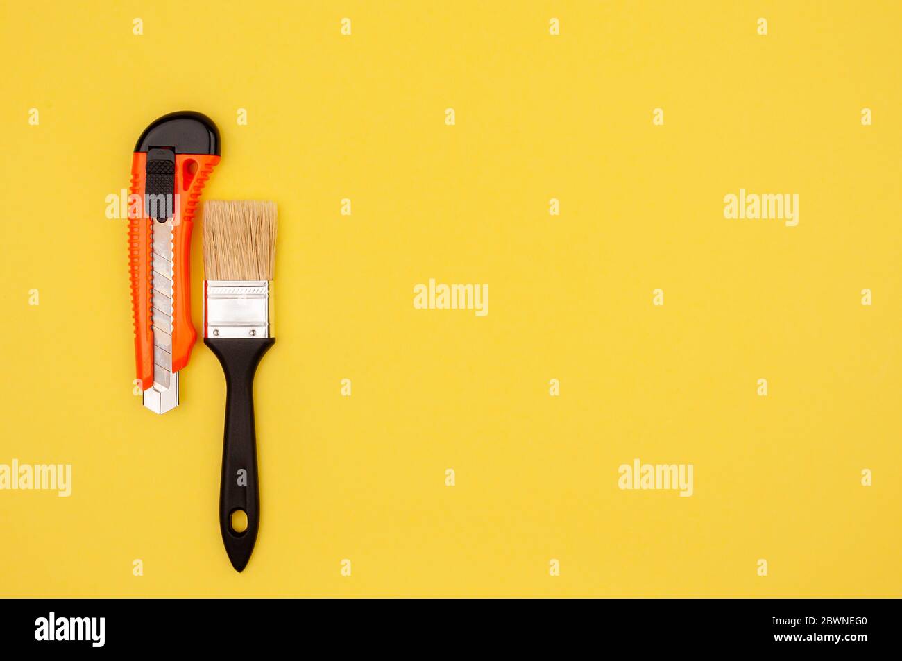 Brush and knife painter on a yellow background. Stock Photo