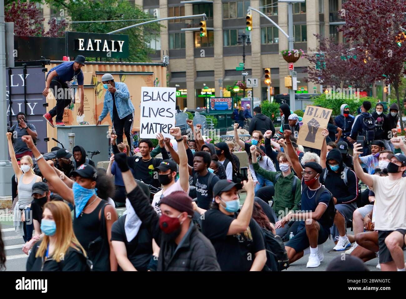 People kneeling, raising fists during a Black Lives Matter march for George Floyd and victims of police brutality, Manhattan, New York, June 1, 2020 Stock Photo