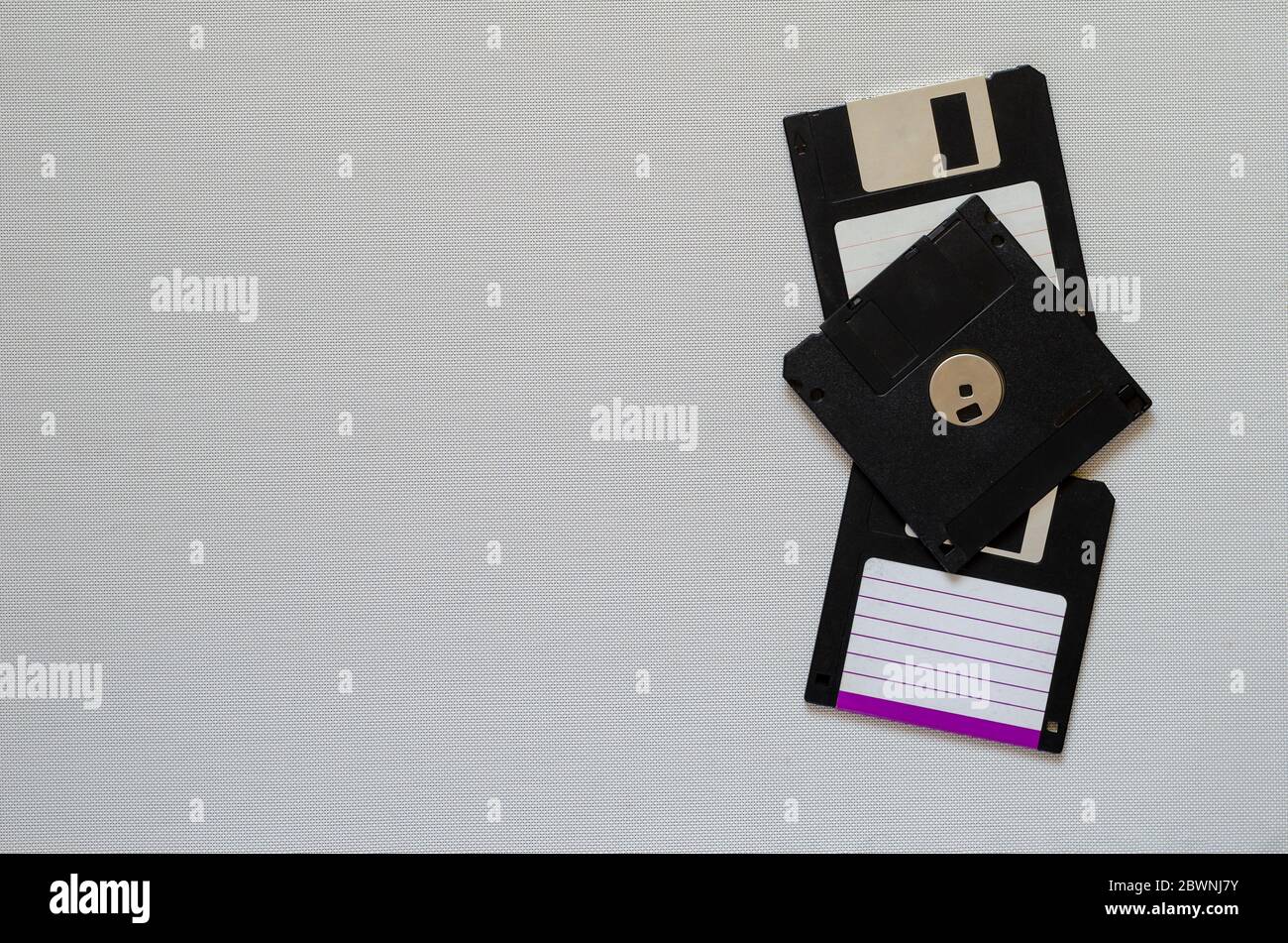 3.5 inch magnetic floppy disks. Three floppy disks with a capacity of 1.44 MB. Obsolete digital data storage media. Copy space Stock Photo