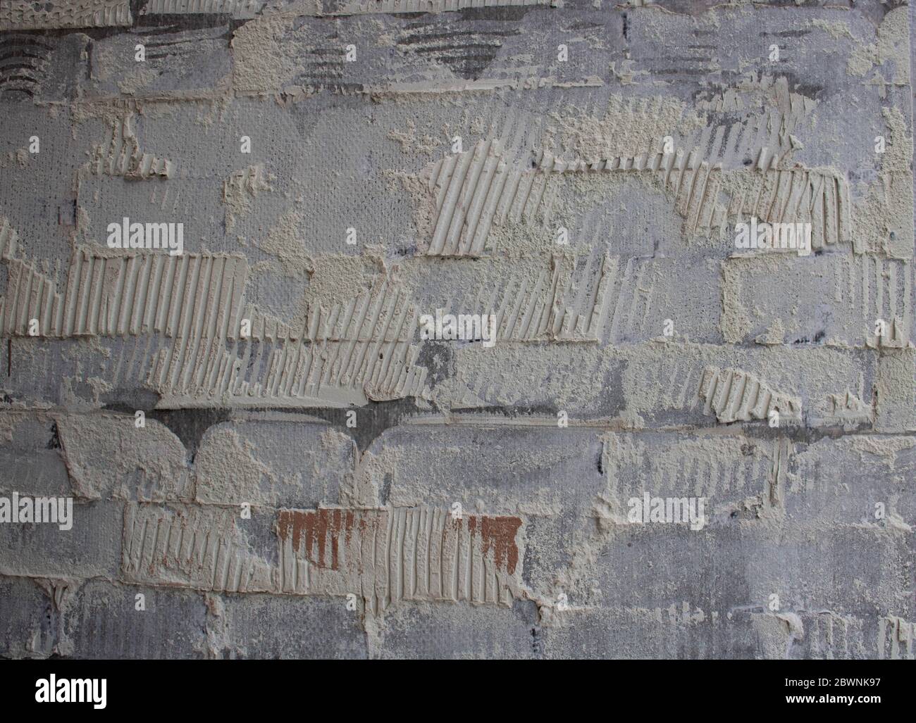 old tile glue or cement . broken wall tiles.wall without tiles Stock