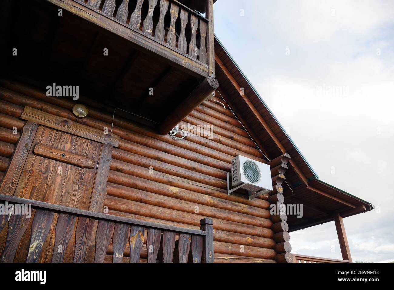 Exterior of log cabin house with air conditioning on the wall Stock