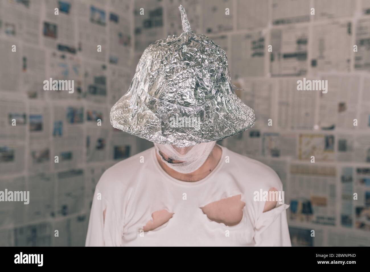 Delusional paranoid man with tin foil hat talking in mind control concept Stock Photo