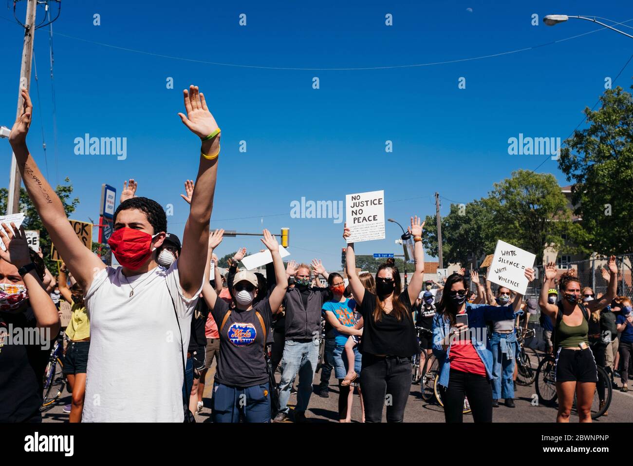 Protesters hold up their hands in a moment of silence in front of the Minneapolis police 5th precinct, Saturday, May 30, 2020 Stock Photo
