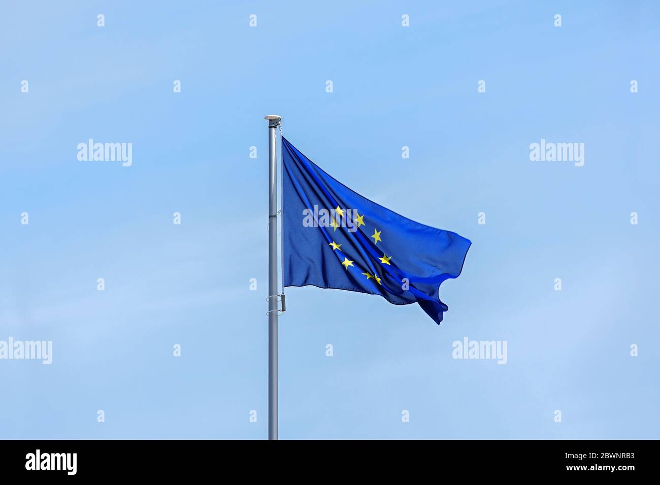 European flag with yellow stars for each member state on a blue background waving in the wind against a bright sky, large copy space on all sides, par Stock Photo