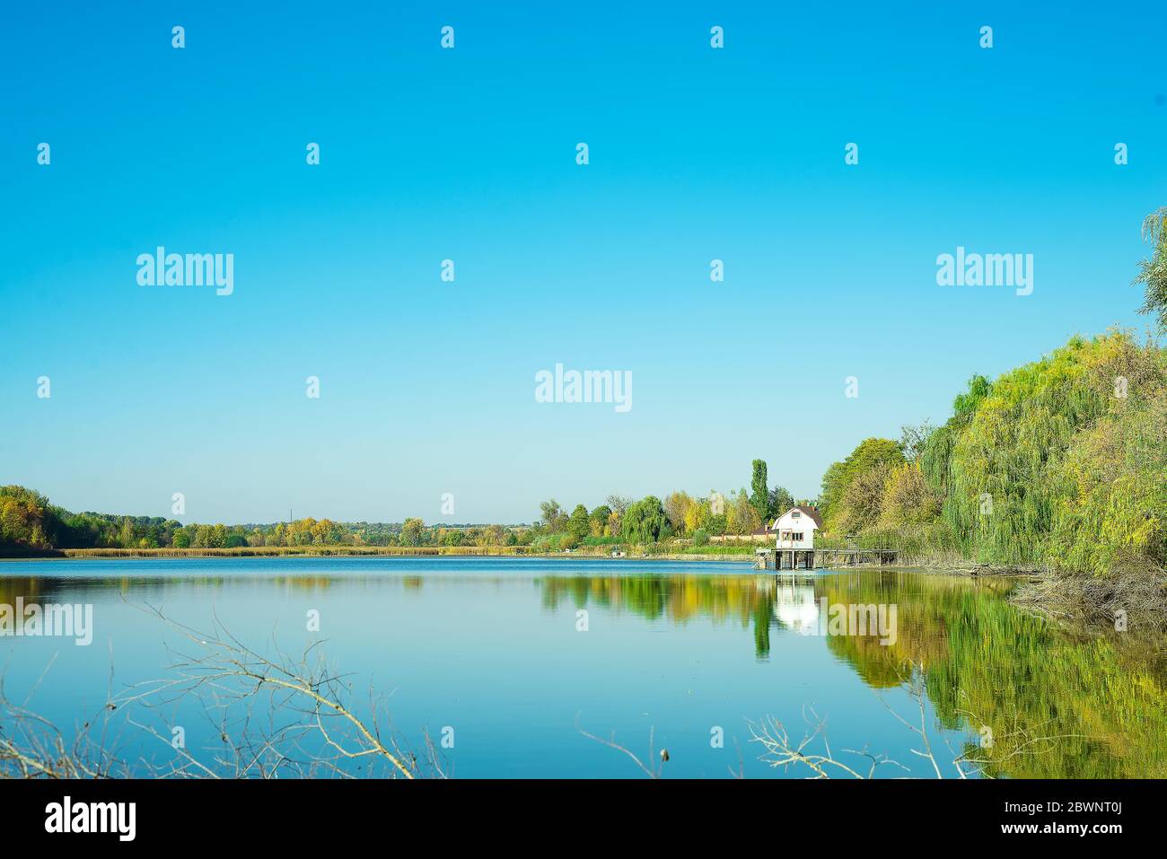Amazing landscape of lake with clear green water and Perfect blue sky. Ukraine Stock Photo
