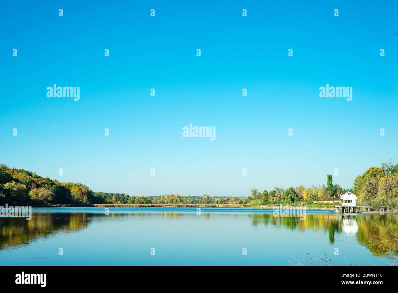 Amazing landscape of lake with clear green water and Perfect blue sky. Ukraine Stock Photo