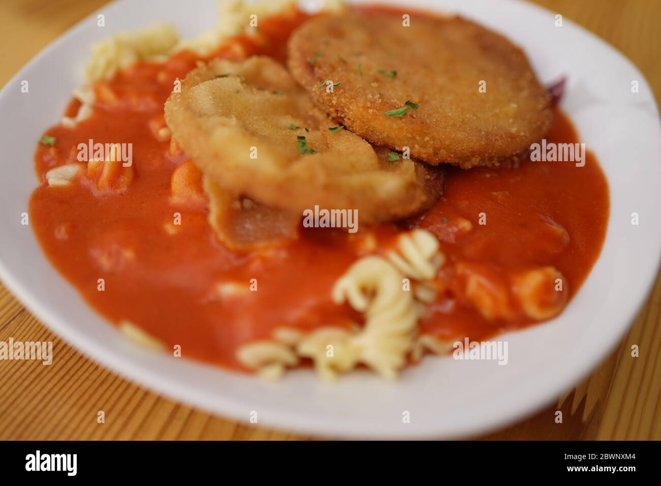 Original German Democratic Republic version of escalope chasseur with breaded Jagdwurst, noodles