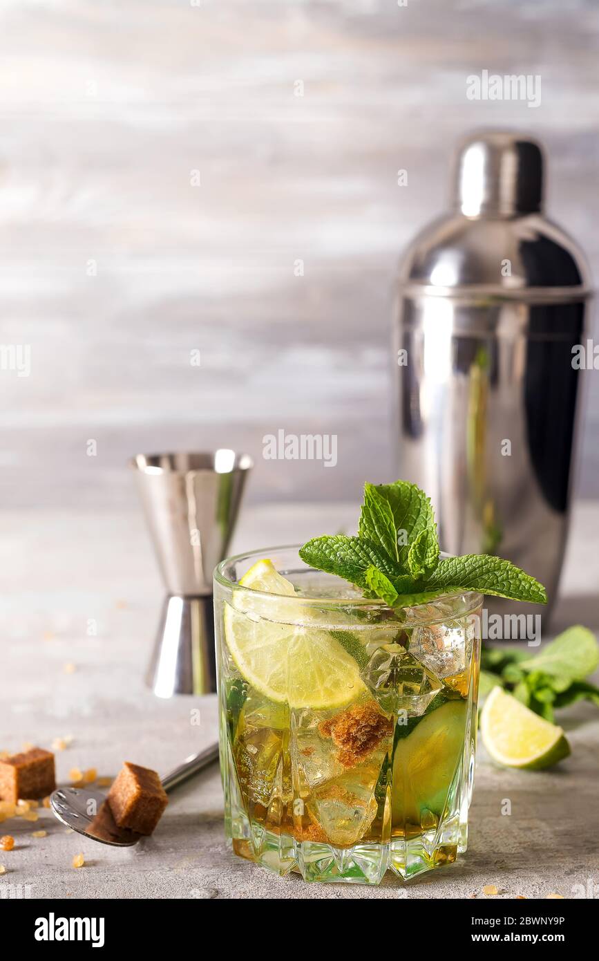 Mojito or Caipirinha cocktail. Brown sugar and an empty glass on stone Stock Photo