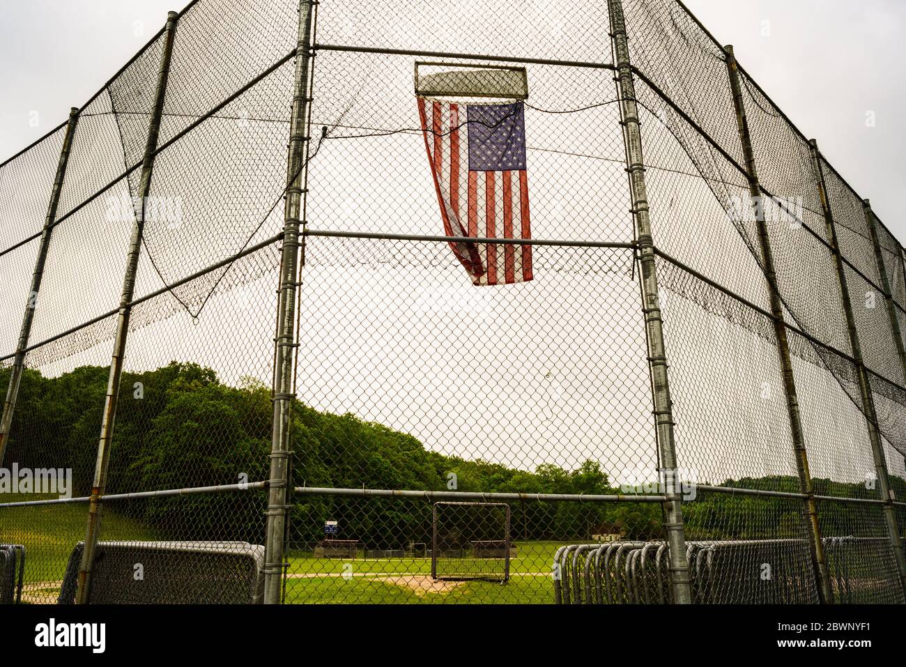 American flag flies on a baseball field, the David L. Feldman Memorial Field, which was empty due to the continued need for social distancing as a result of the Covid-19 pandemic resulting from the coronavirus. Stock Photo